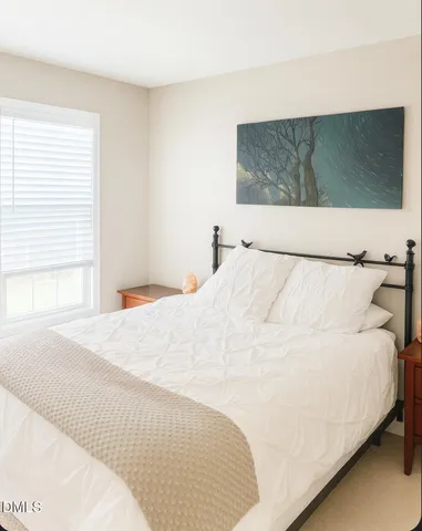 a large white bed in a white room