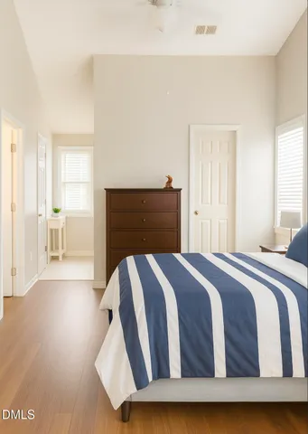 a bedroom with a bed and wooden floor
