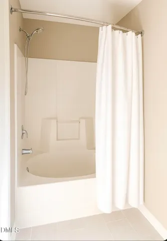 a bathroom with a shower curtain and a bathtub