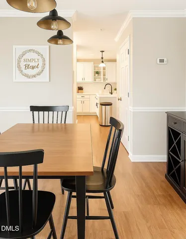 a view of a dining room with furniture and a chandelier