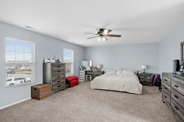 a bedroom with bed and window