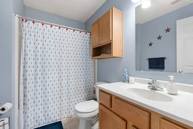 a bathroom with a sink toilet and mirror