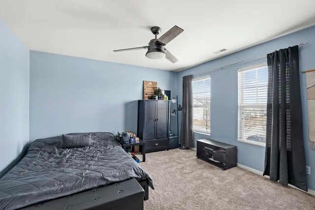 a bedroom with a large bed and a window