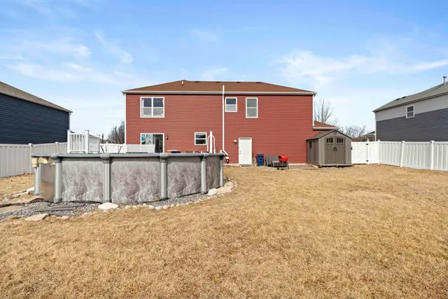 a view of a house with wooden fence