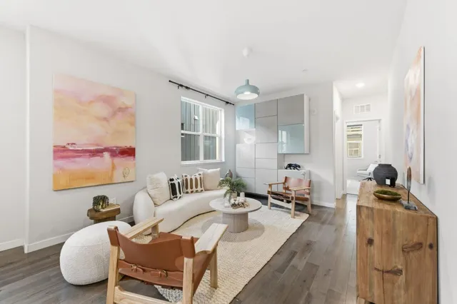 a living room with furniture a couch and a flat screen tv