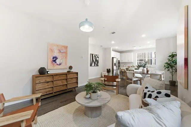 a room with furniture a rug and white walls