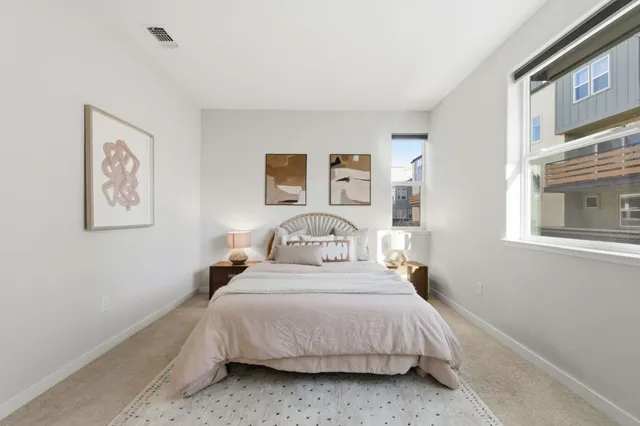 a bedroom with a bed and a wall painting