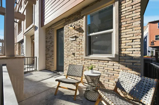 a view of a chairs and a table in the patio