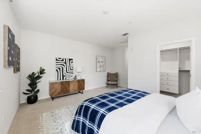 a bedroom with a bed and a couch