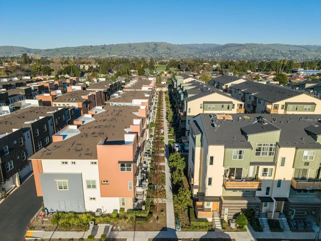 an aerial view of residential houses with outdoor space