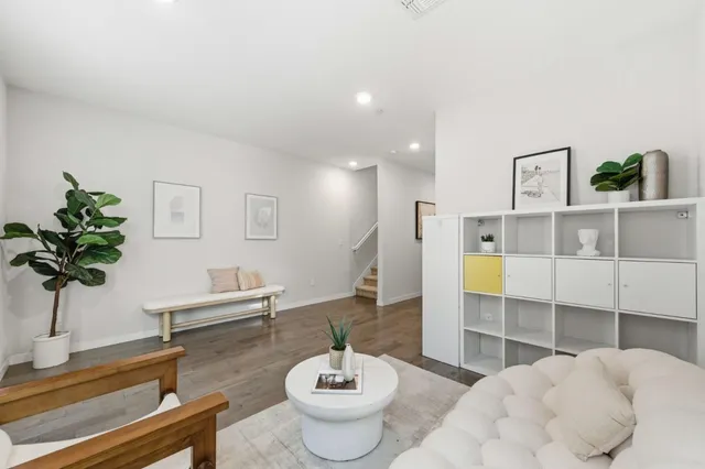 a living room with furniture and a potted plant