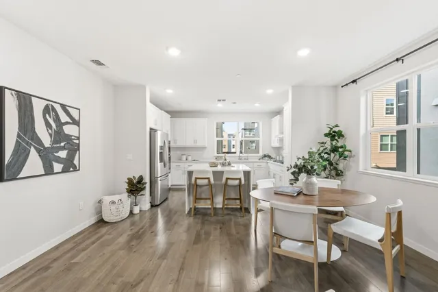 a dining room with furniture and wooden floor