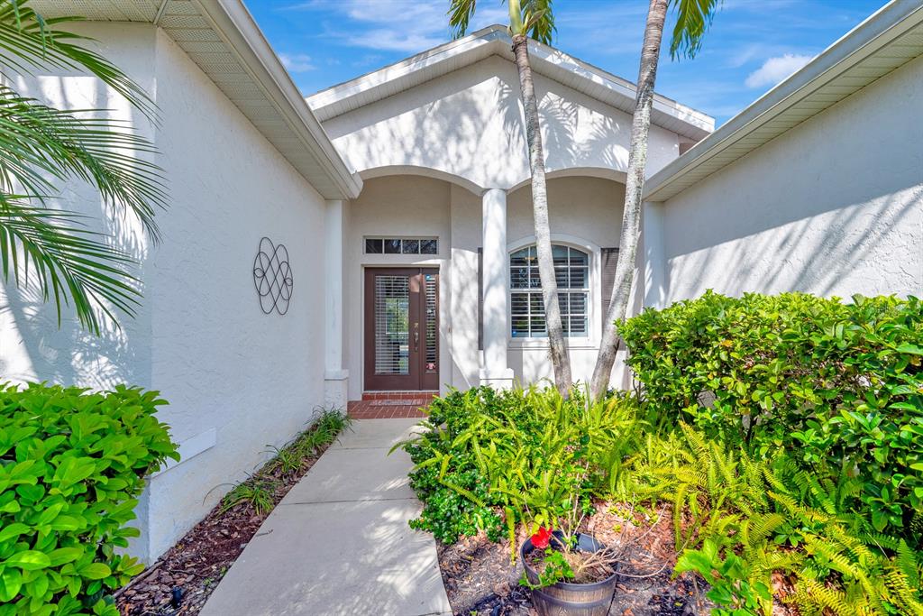 7344 Arrowhead Run Lakewood Ranch, FL 34202 - Photo 2 of 24 a view of a house with potted plants