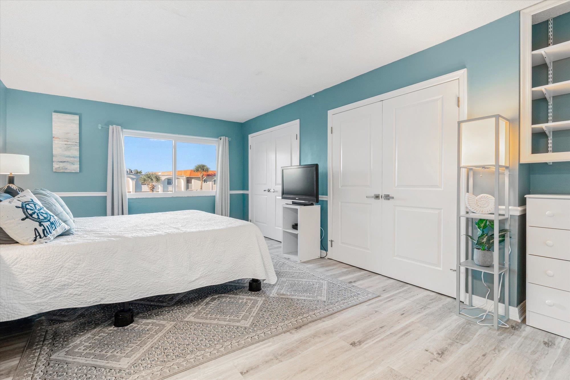 1 Ocean Trace Road, Unit 242 St. Augustine, FL 32080 - Photo 14 of 66 a spacious bedroom with a bed and a cabinets