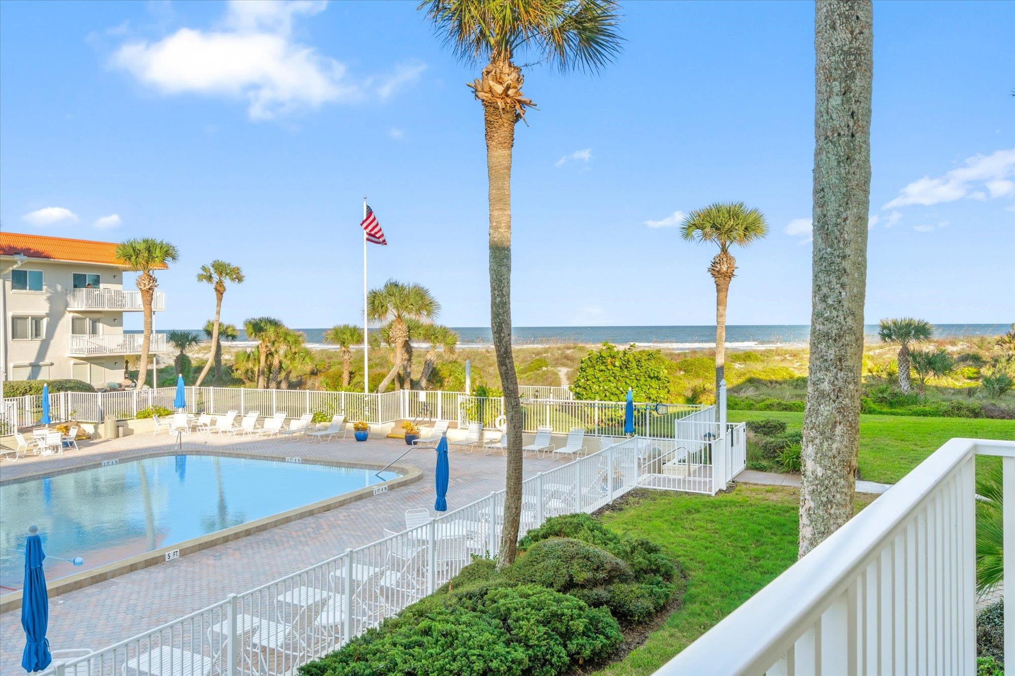 1 Ocean Trace Road, Unit 242 St. Augustine, FL 32080 - Photo 18 of 66 a view of a swimming pool with a lawn chairs