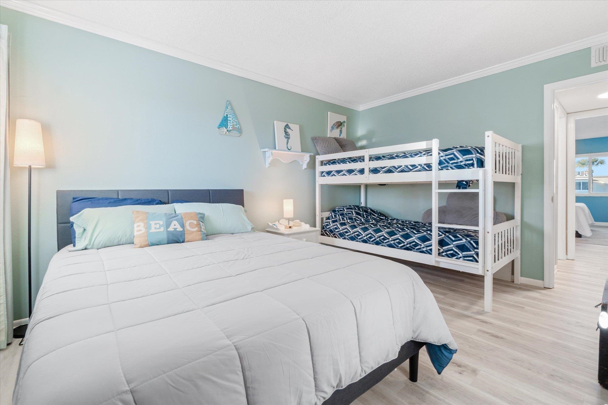 1 Ocean Trace Road, Unit 242 St. Augustine, FL 32080 - Photo 21 of 66 a bedroom with a bed a dresser and a potted plant