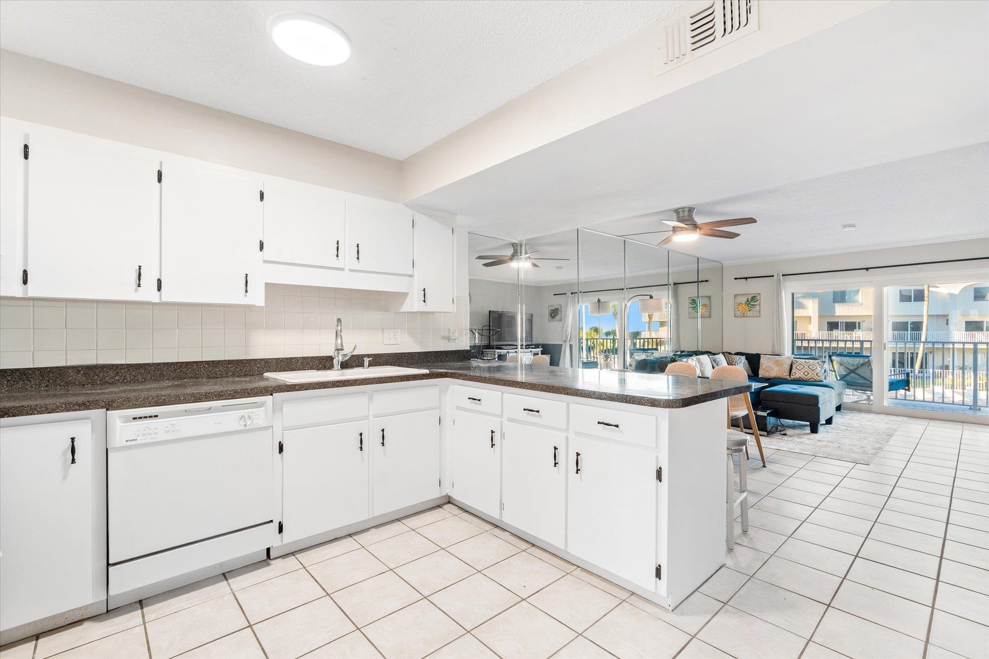 1 Ocean Trace Road, Unit 242 St. Augustine, FL 32080 - Photo 66 of 66 a kitchen with white cabinets a sink and appliances