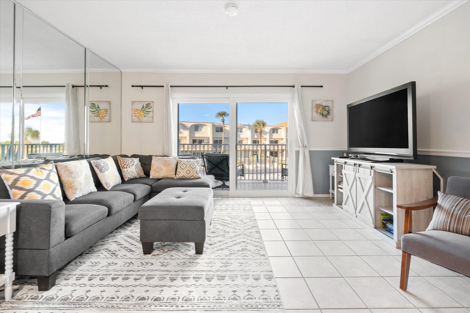 1 Ocean Trace Road, Unit 242 St. Augustine, FL 32080 - Photo 9 of 66 a living room with furniture and a flat screen tv