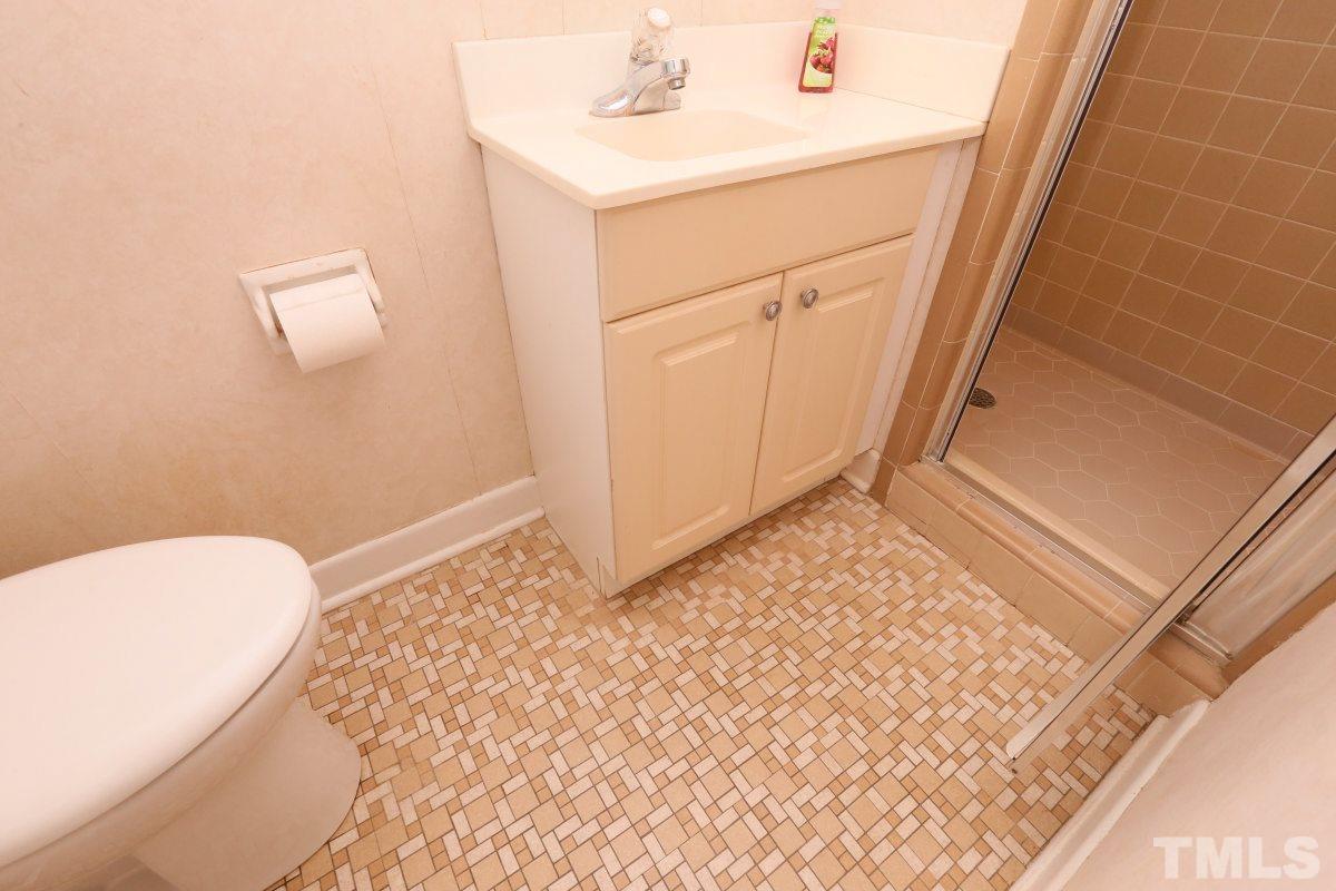 1913 Highland Place Raleigh, NC 27607 - Photo 14 of 25 a bathroom with a sink a toilet and a mirror