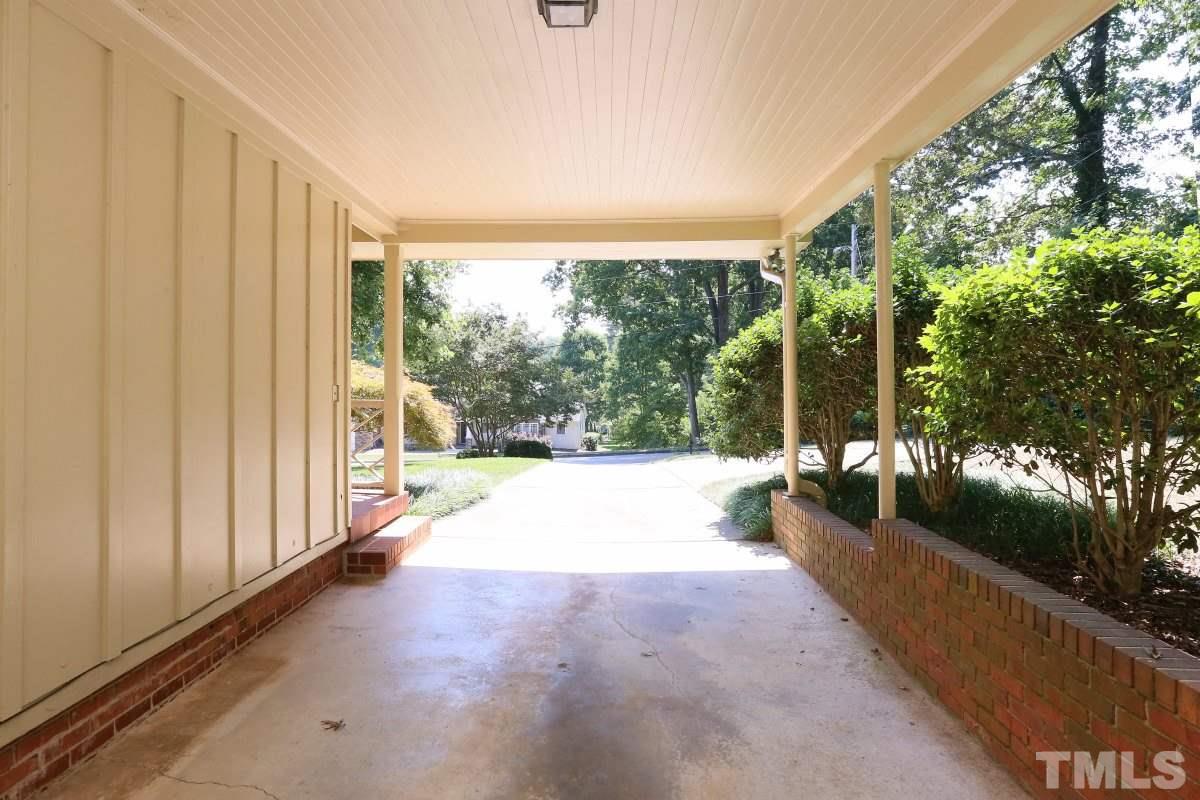 1913 Highland Place Raleigh, NC 27607 - Photo 22 of 25 a view of a patio with table and chairs in front of a yard with wooden fence
