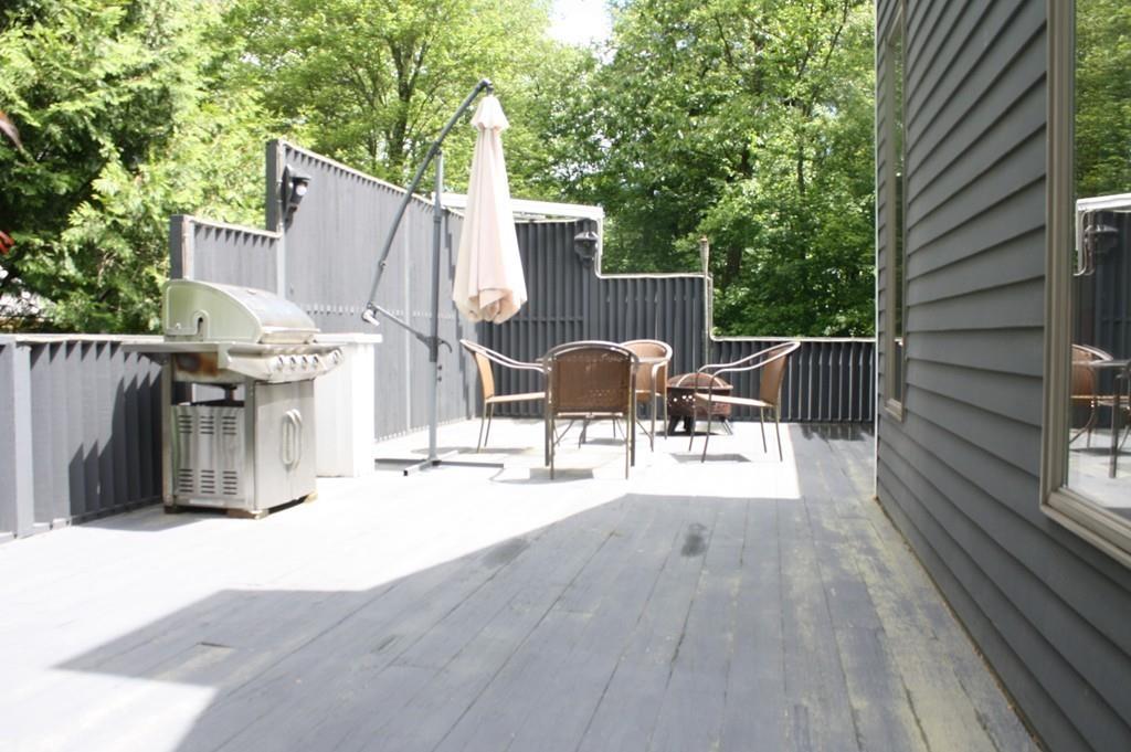 82 Stillwater Road Deerfield, MA 01373 - Photo 15 of 22 a view of a patio with table and chairs and wooden floor