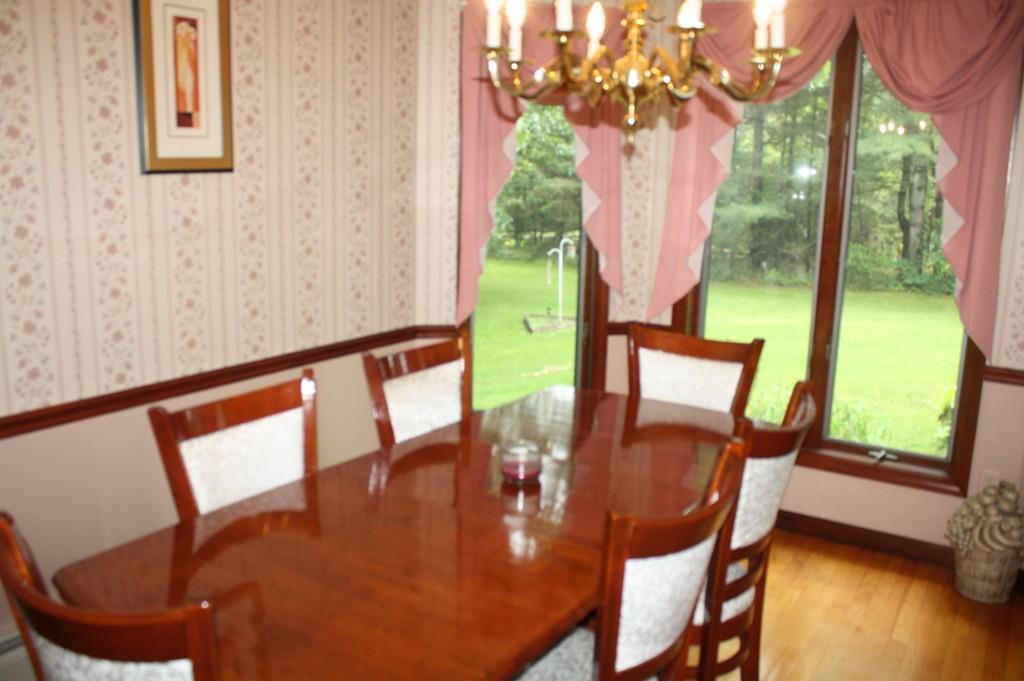 82 Stillwater Road Deerfield, MA 01373 - Photo 9 of 22 a view of a dining room with furniture a chandelier swimming pool and wooden floor