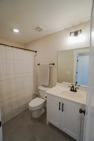 a bedroom with a bed and a desk