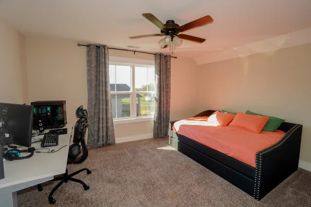 a bedroom with a workspace