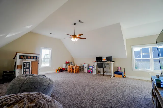 a living room with baby crib furniture and a wooden floor