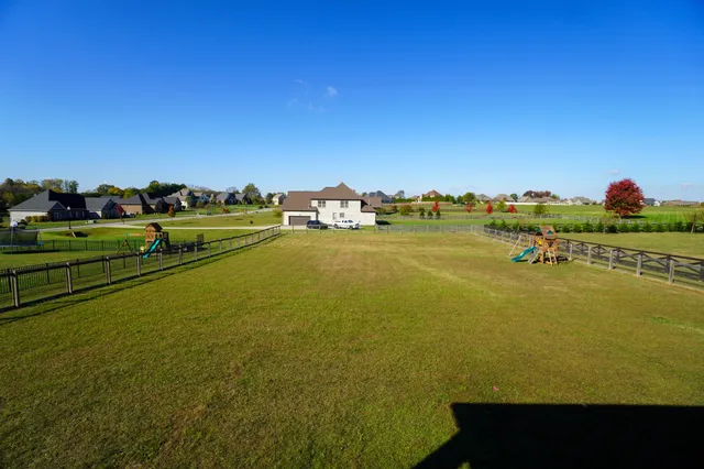 a view of a swimming pool with a chairs and a table