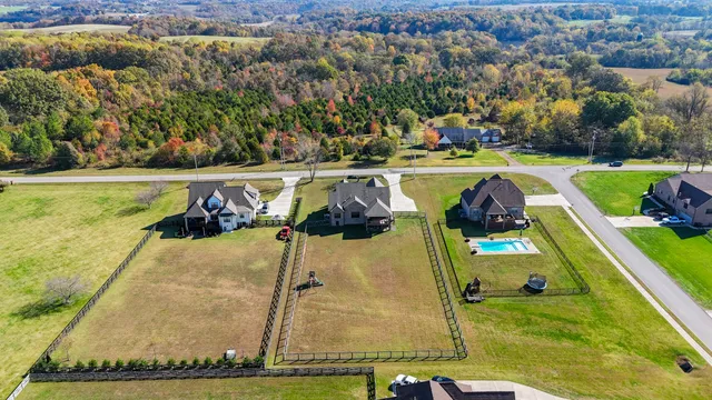 an aerial view of a house with a garden and a yard