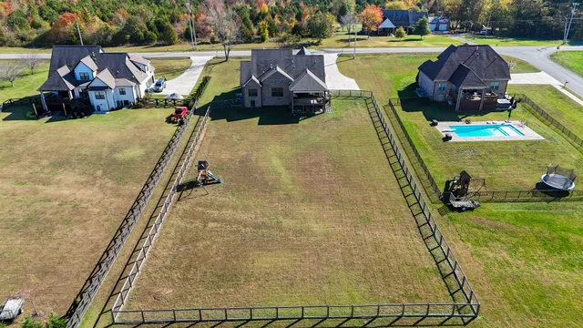 a porch with a bench next to a yard