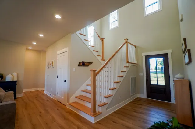 a view of entryway with wooden floor and stairs