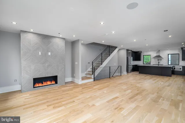 a view of an empty room with a fireplace and a hallway