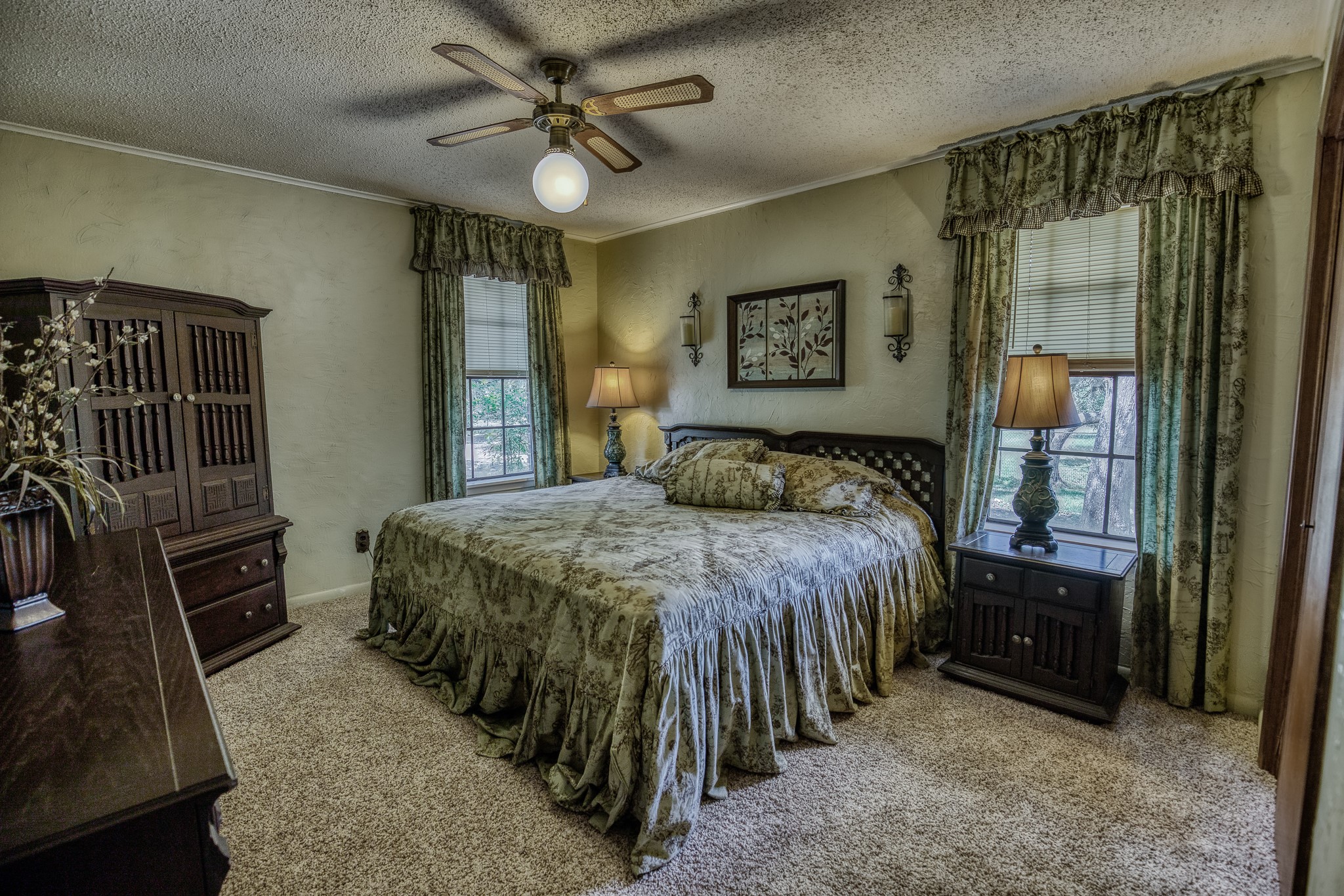 10639 Palestine Road Brenham, TX 77833 - Photo 25 of 42 a bedroom with a bed and a chandelier
