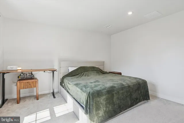 a bedroom with a bed and a mirror