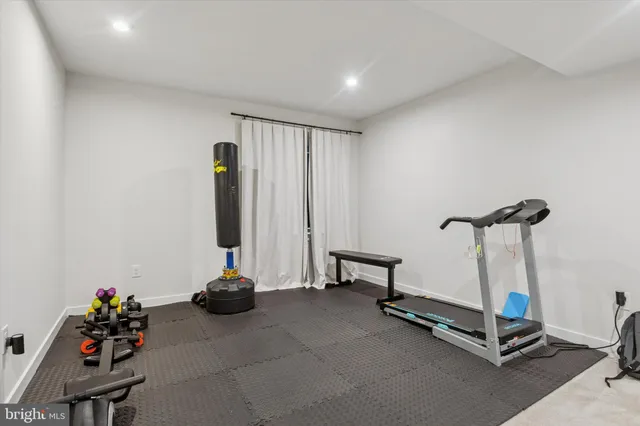 a room with gym equipment and a large window
