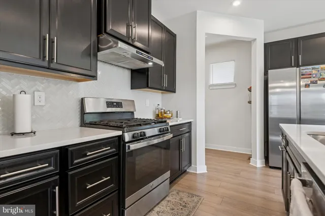 a kitchen with stainless steel appliances granite countertop a stove and a refrigerator