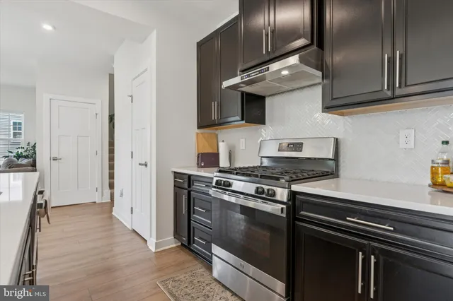 a kitchen with stainless steel appliances granite countertop a stove and a refrigerator