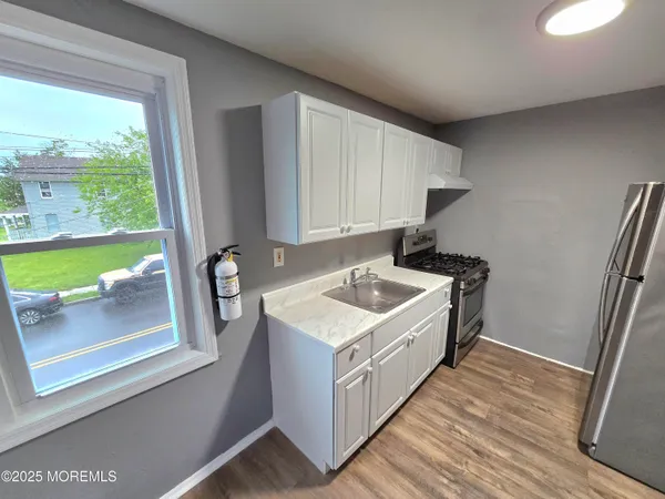 a kitchen that has a sink and a stove