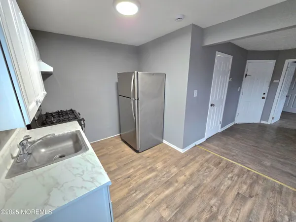 a kitchen with a sink stove and refrigerator