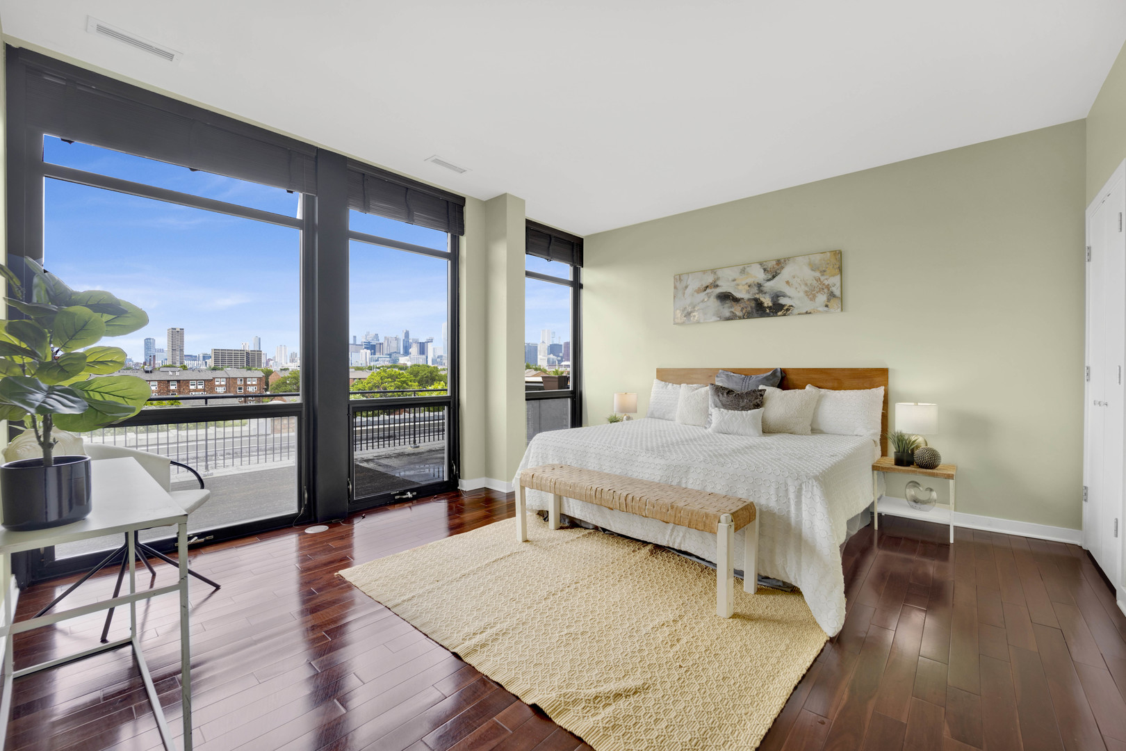 1069 West 14th Place, Unit 323 Chicago, IL 60608 - Photo 14 of 43 a bedroom with a bed and wooden floor