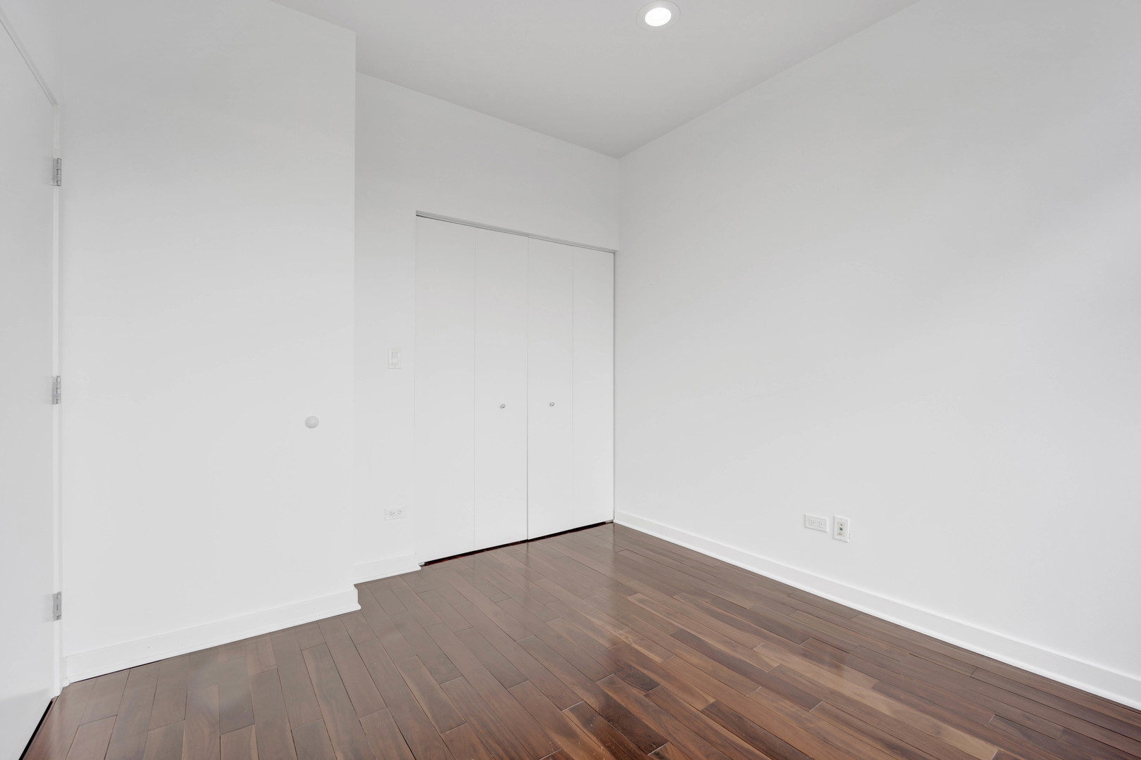 1069 West 14th Place, Unit 323 Chicago, IL 60608 - Photo 21 of 43 a view of an empty room with wooden floor