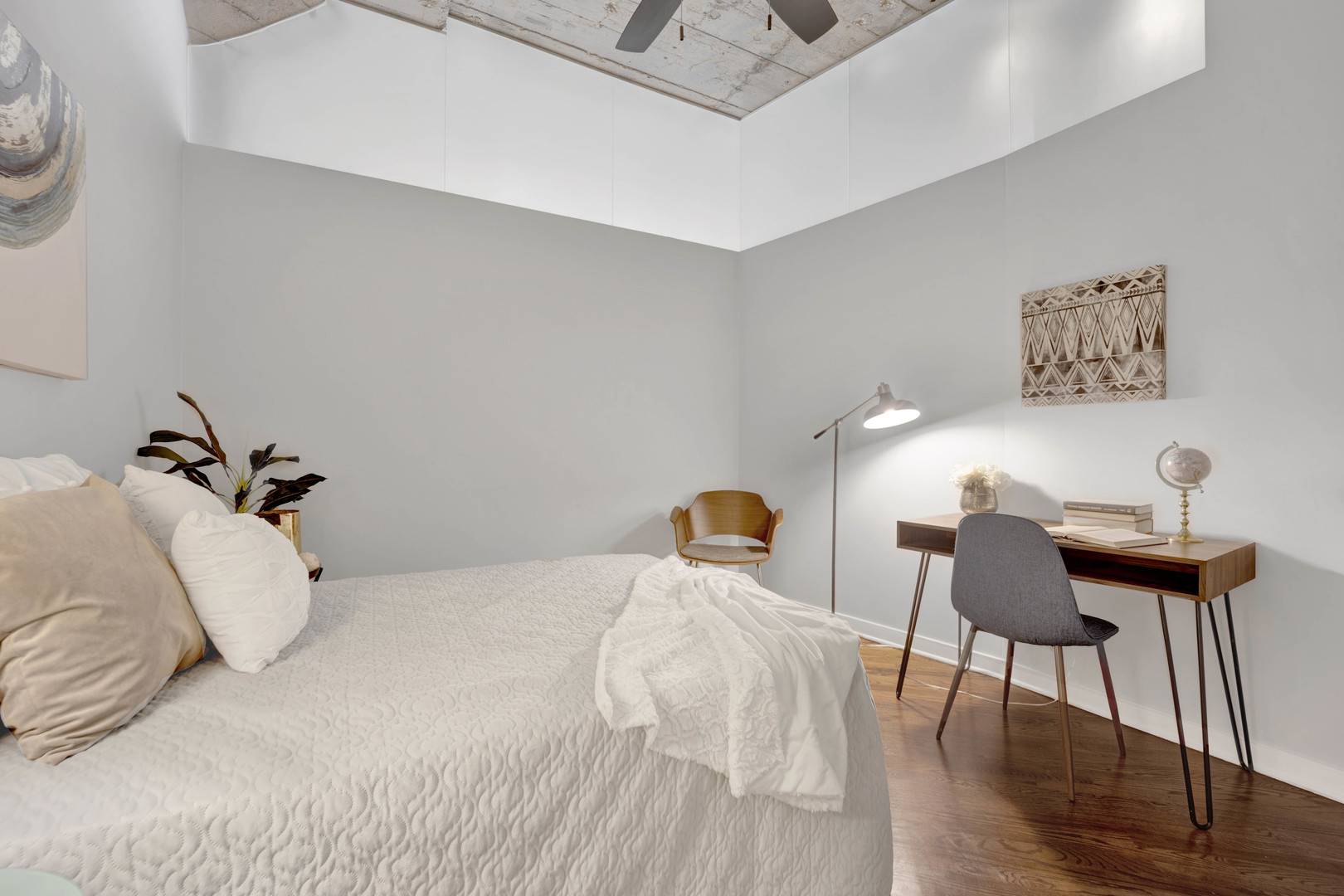 1069 West 14th Place, Unit 323 Chicago, IL 60608 - Photo 23 of 43 a bedroom with bed and a chair
