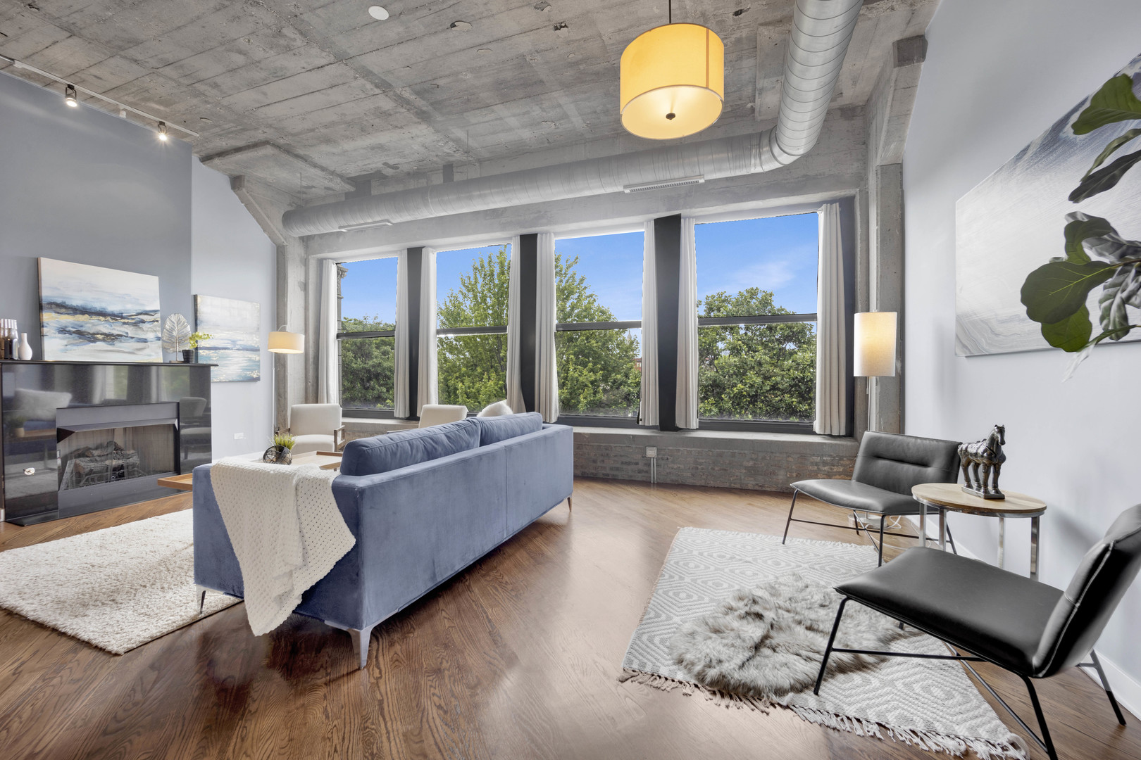 1069 West 14th Place, Unit 323 Chicago, IL 60608 - Photo 5 of 43 a living room with furniture and a large window
