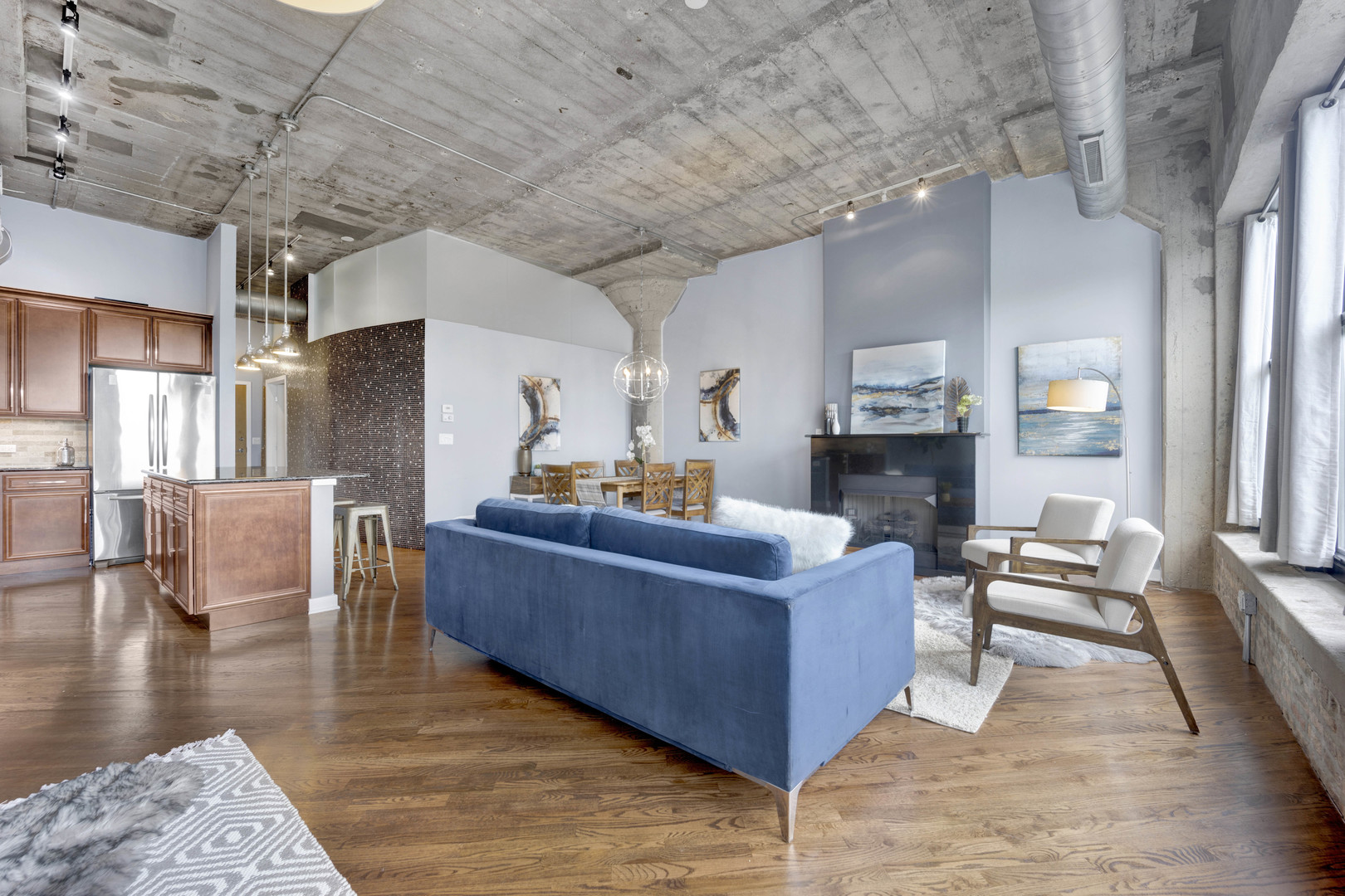 1069 West 14th Place, Unit 323 Chicago, IL 60608 - Photo 6 of 43 a living room with fireplace furniture and a wooden floor
