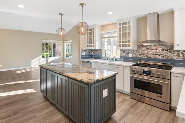 a metallic refrigerator freezer sitting in a kitchen