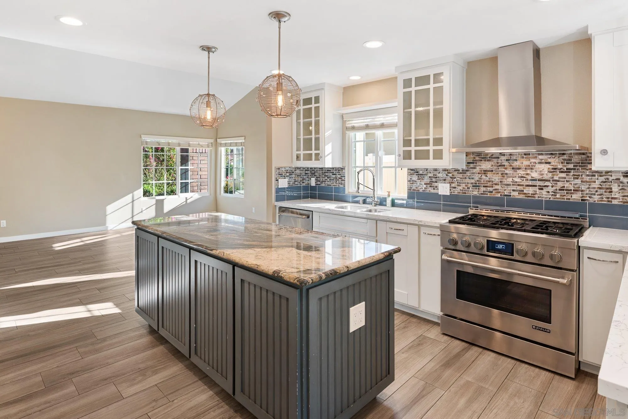 14274 Woodcreek Road Poway, CA 92064 - Photo 12 of 57 a kitchen with stainless steel appliances granite countertop a stove a sink and a wooden floor