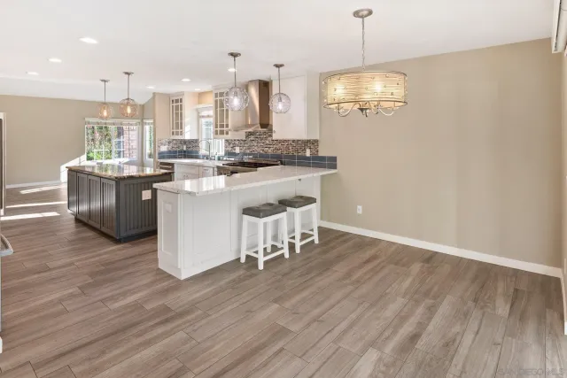 a view of a kitchen with kitchen island dining table and stainless steel appliances