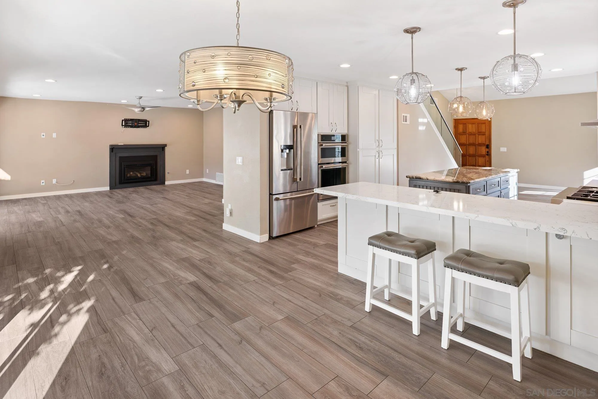 14274 Woodcreek Road Poway, CA 92064 - Photo 17 of 57 a view of a kitchen with kitchen island dining table and stainless steel appliances